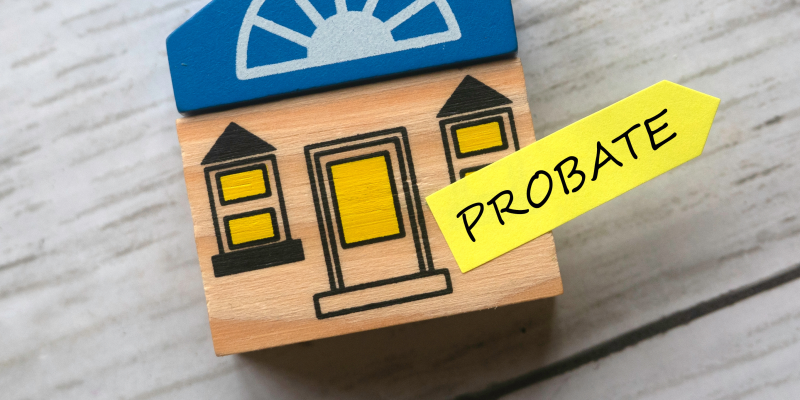 WillsProbateImg A toy wooden house with a yellow arrow sticker that says probate