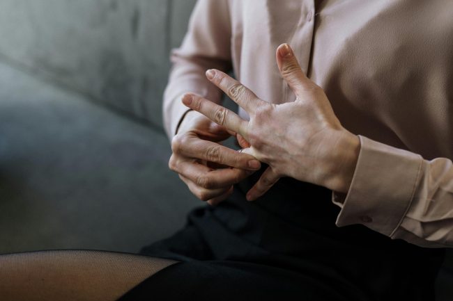 A woman taking her wedding ring off