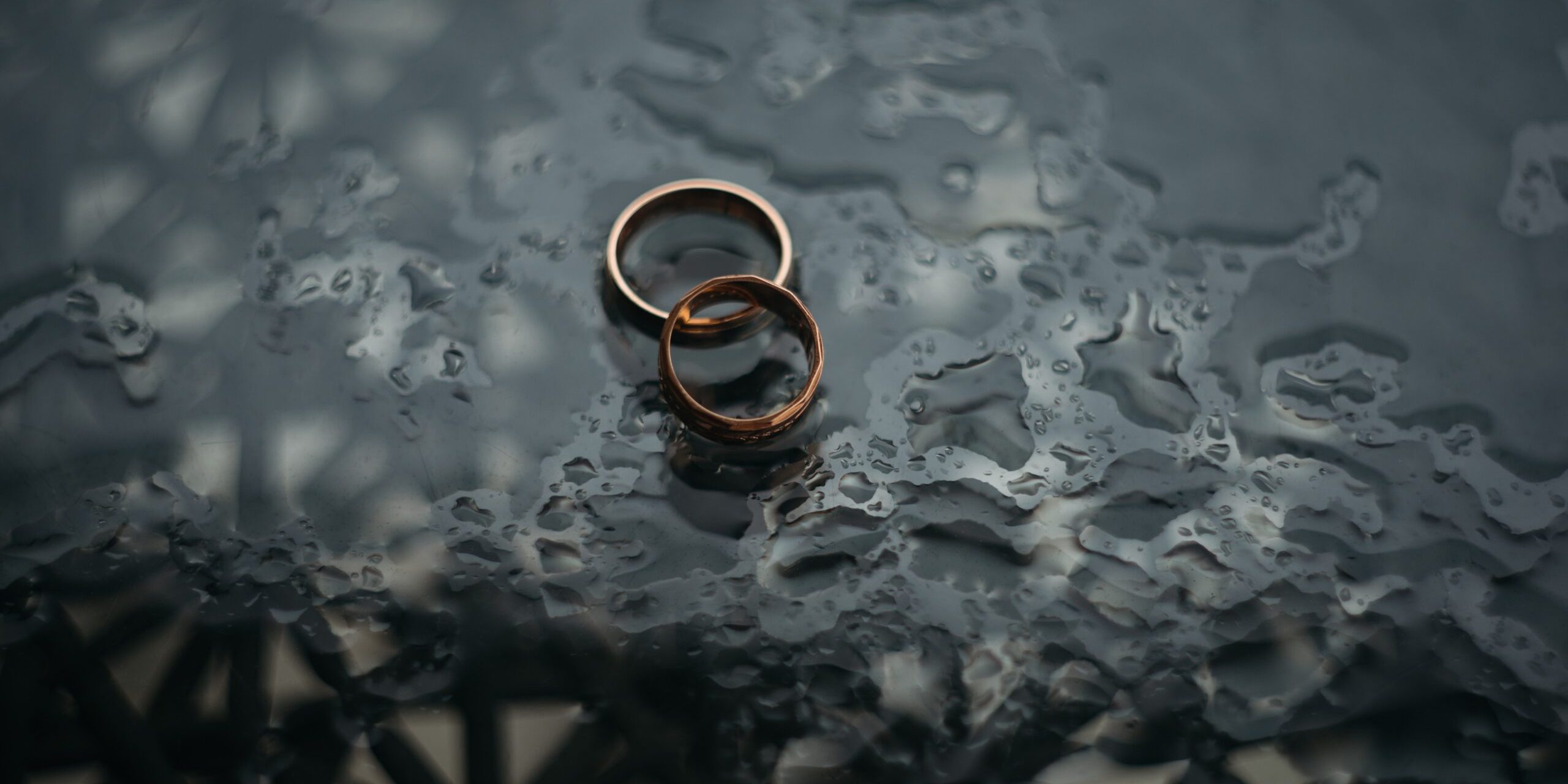 Divorce 4 Two gold rings on a wet surface