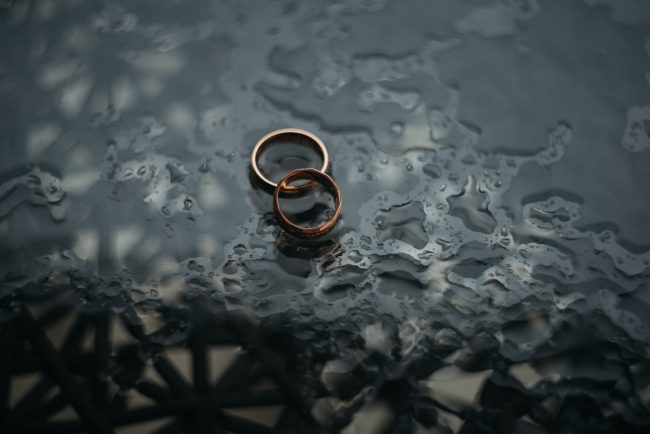 Two gold rings on a wet surface