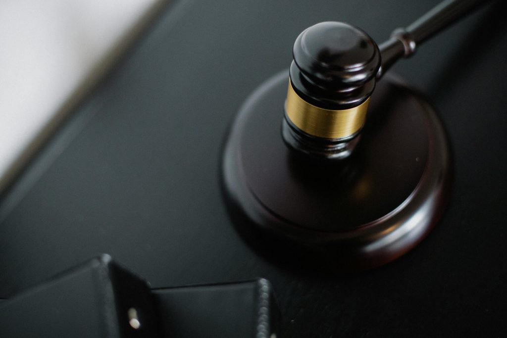 A gavel hitting a wooden circle
