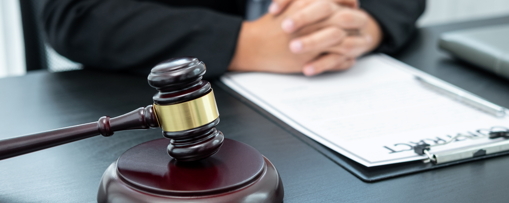 A judges desk with a contract and a wooden gavel