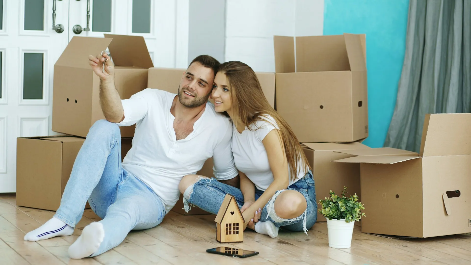 A house key being handed to a new owner